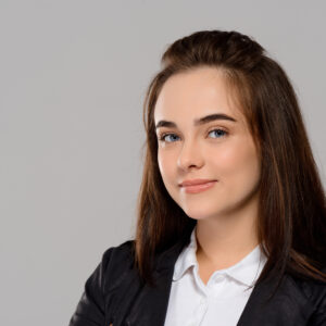 young beautiful girl smiling, posing over purple background.